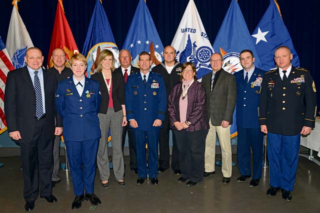 Photo by Richard HermanThe nominees for the EUCOM Service Members and Civilians of the Year award pose for a photo opportunity with Maj. Gen. Mark Barrett, EUCOM chief of staff (center) and EUCOM Command Sgt. Maj. Randy Woods (far right) at the Patch Theater Jan. 31. The command announced their outstanding service members and civilians of the year during the ceremony.