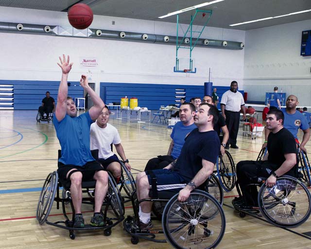 Photo by Linda SteilThe Warrior Transition Unit composite team (in blue) battles against a team representing the Special Operations Command in a game of wheelchair basketball Feb. 28 during an adaptive sports tournament sponsored by the Warrior Transition Battalion-Europe.