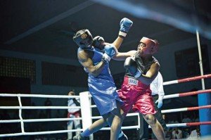 Xavier Martin of Team Stuttgart (in blue) squares off against Corey Taylor of Hohenfels in a very heated 13th bout during the Rumble in the Gart invitational boxing tournament at Patch Fitness Center April 5. Boxers from around Germany gathered to test their mettle against one another in this 15-bout points- based tournament.  Laura Castro 