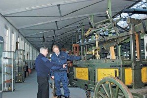 Photo by Carola MeuselBernd Jung, chairman of the Feuerwehrverein Stuttgart, explains features of a manually- operated fire pump from 1835 to Karl Doersam, USAG Stuttgart’s fire chief, at the “Feuerwehr-Museum” Stuttgart, Jan. 27. The museum features firefighting equipment through the ages, as well as 25 fire trucks from the 1940s up to the 1980s.