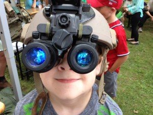 Photo by Lt. Cmdr. Dave Hecht, USAFRICOM Public Affairs.Charlie Hecht tries on a pair of night vision goggles that were on display at the Special Operations Command Africa tent.