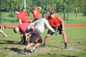 Photo by Chief Petty Officer Mark Richardson, USAFRICOM Public Affairs.MARFORAF (in red) goes on defense as SOCAF tries to score in a flag football game during the fourth annual AFRICOM Olympics July 8 at Kelley Barracks. 