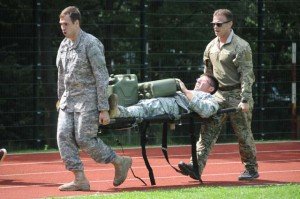 Photo by Chief Petty Officer Mark Richardson, USAFRICOM Public Affairs.Team SOCAF take part in the mystery event, carrying a teammate on a cot weighted down with jugs of water.