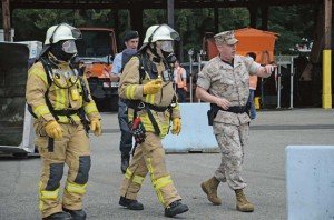 USAG Stuttgart firefighters Sebastian Kopp (from left) and Dieter Doerfler are first on the scene and get briefed by Staff Sgt. Christopher Williamson. 