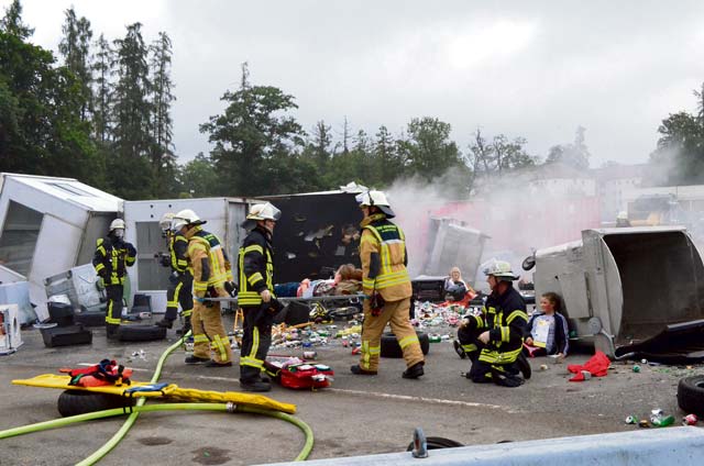 USAG Stuttgart firefighters (in tan), along with firefighters from the city of Stuttgart, clear the “injured” from the scene of a simulated VBIED detonation July 12 on Kelley Barracks during Stallion Shake 2014, USAG Stuttgart’s annual allhazards exercise.