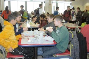 Photo by Carola MeuselDamir Ikic (from right), Luka Martinovic, and Ermin Aliti, all eighth-graders at Johannes-Kepler-Gymnasium in Bad Cannstatt, have lunch at the food court on Patch Barracks Feb. 25 with PHS sophomore Elijah Philips. Some 21 German students visited PHS as part of a USO-organized school outreach program.