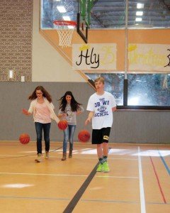 Photo by Carola MeuselAlma Hasanbasic (from left) and Aria Emir, eighth graders at Johannes-Kepler-Gymnasium in Bad Cannstatt, along with Patch High School ninth-grader Sean Loeben, practice dribbling basketballs during physical education in the PHS gymnasium Feb. 25, as part of a school outreach program.