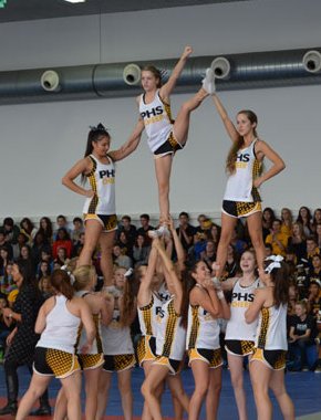 The PHS cheerleading squad fires up the students during the pep rally Oct. 17 in the Patch Fitness Center. The squad also gave out candy, encouraged loud cheering and honored the homecoming court king and queen with flowers.