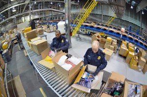 Each day, CBP helps to prevent the intentional and  unintentional introduction of potentially harmful plant pests and foreign animal diseases from  entering the U.S. In this photo, CBP agents inspect mail at a Cleveland, Ohio,  facility. Photo by Brian Bell.  