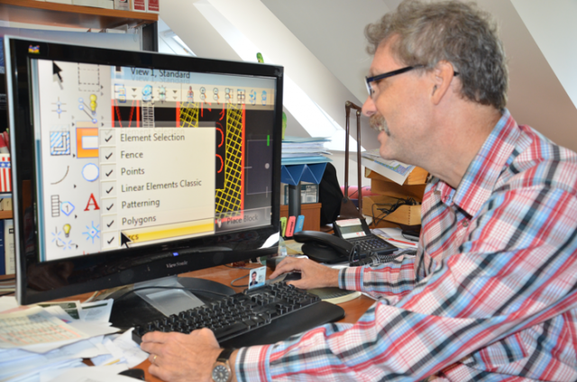 Man at desk in front of computer