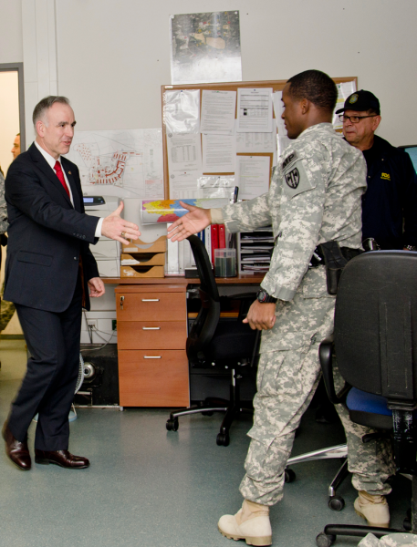 Michael Formica, (left) the IMCOM Europe region director, greets Spc. Tymire Lewis, 554th MP Company, and Sgt. Hector Vazquez, a civilian police officer with the Directorate of Emergency Services, during his visit to the Military Police Station on Patch Barracks Feb. 10.