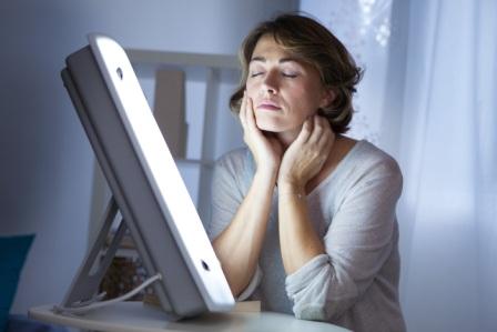 With SAD light therapy, a patient sits in front of a light box for about 30 minutes a day. — Photo by Shutterstock.com.