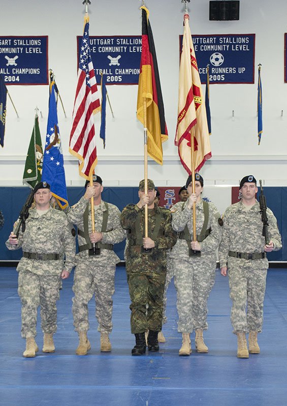 An international color guard retires the U.S. and German flags, as well as the unit colors of USAG Stuttgart during the USAG Stuttgart Change of Command ceremony Feb. 27 at Patch Fitness Center, Patch Barracks, Stuttgart, Germany. Photo by Greg Jones, USAG Stuttgart Public Affairs.