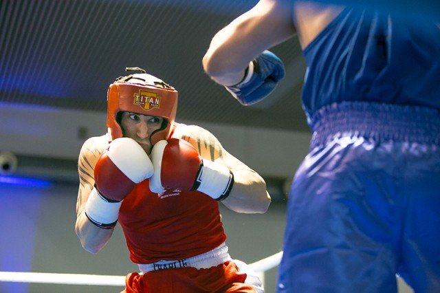 Denise Romano, of Rommelshausen, who ultimately won best boxer for the tournament, keeps his eyes intensely focused on the gloves of opponent Pascal Paxe of Waiblingen.