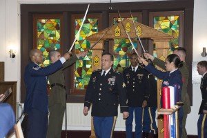 : Incorporating the traditions of the Army, Air Force and Marine Corps, inductees at the first ever Stuttgart Joint Services Noncommissioned Officer Induction Ceremony, walk through a wooden archway of army NCO ranks followed by the arched sabers of the Air Force and Marine corps. Not visible in the photo, a petty officer rang a bell for each inductee, in accordance with Navy tradition. The ceremony was held April 30 at Patch Chapel, Patch Barracks, Stuttgart.