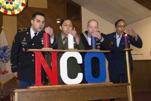 Representatives from all four services simultaneously blow out the NCO candles during the first ever Stuttgart Joint Services NCO Induction Ceremony April 30 at Patch Chapel, Patch Barracks, Stuttgart.
