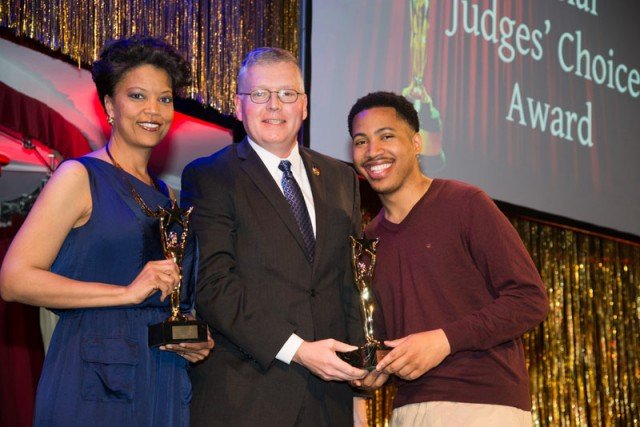 Tonya Holloway and Christopher Mazen pose for a photo with Col. Shawn Wells (center), the USAG Rheinland-Pflaz commander, after receiving their Judges’ Choice awards for “Her Stories.”