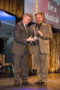 Richard Roberts receives the Best Set Design for a Musical Topper award from Col. Glenn Dickenson, the USAG Stuttgart commander.