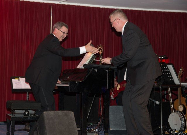Alan Buxkemper, who was “working” during the awards ceremony, receives the Best Instrumentalist Topper award.