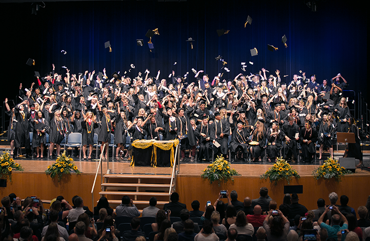 Patch High School seniors toss their mortar boards into the air at the conclusion of their graduation ceremony held June 2 in the Sindelfingen Stadthalle. The Class of 2015 is the final graduating class for the school that has served the Stuttgart military community since 1979. Photo by Virginia Kozak, Patch High School.