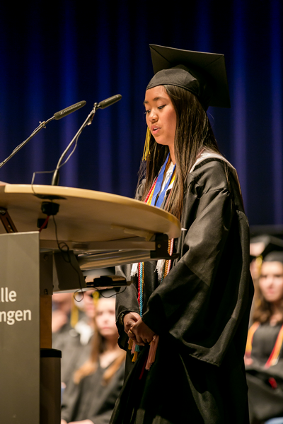 Sharmaine Poblete, valedictorian, addresses the audience of families, friends and educators. Photo by Virginia Kozak, Patch High School.