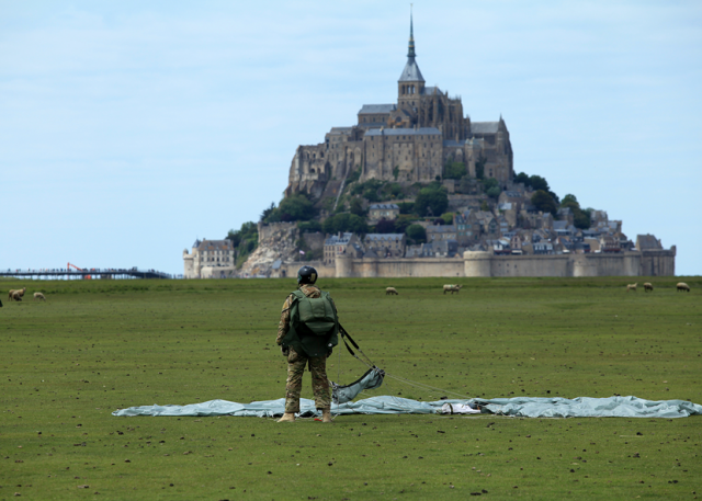 In the first events commemorating the 71st anniversary of the liberation of France, Special Operations Command Europe operators performed military free falls into U.N. designated world heritage site in Mont Saint-Michel May 30. After a safe landing, the operator takes stock of his new location before picking up his parachute and moving in to greet the watching French crowd. Photo by Sgt. 1st Class Will Patterson, SOCEUR Public Affairs.