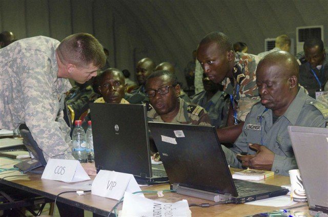 Lt. Col. Jonathan Shine, commander, 4th Battalion, 1st Field Artillery Regiment, 3rd Brigade, 1st Armored Division, works with central African military personnel during the preparation phase of Central Accord 2015 in Libreville, Gabon, May 14. Shine and his counterparts developed a plan of action for events taking place during the exercise. CA 15 exercises mission command proficiency for UN peacekeeping operations, develops multinational logistical and communications capabilities, and improves regional ability to command, control and support forward deployed forces. Approximately 400 military personnel from member nations are scheduled to participate in the exercise. The exercise consists of one week of classroom-based academics and one week of a command post exercise. (U.S. Army Africa photo by Staff Sgt. Michael Folkerth)