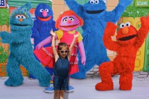 Quinn Lai poses on her way in to see Sesame Street friends perform live at Patch Fitness Center. 