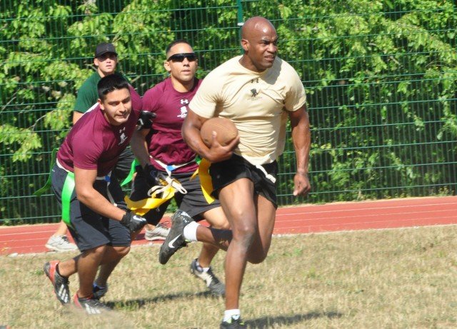 A Special Operations Command Africa player outruns players from U.S. Marine Corps Forces Africa during a flag football game at the fifth annual AFRICOM Olympics Aug. 7. Held at Kelley Barracks, the AFRICOM Olympics offers a day of fun and camaraderie through sporting competitions, games and family entertainment.