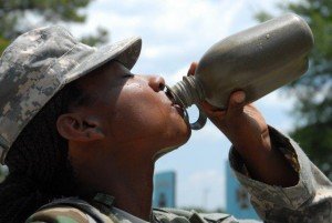Photo Credit: Ms. Crystal Lewis Brown (Fort Jackson Leader)In this U.S. Army file photo, Pvt. Shantes Baxter, a Basic Combat Training Soldier with Company B, 3rd Battalion, 13th Infantry Regiment, takes a drink from her canteen during a break. Those performing heavy physical activity in the heat should drink two to four glasses of cool fluid each hour, according to the Centers for Disease Control and Prevention. These fluids should be non-alcoholic and not contain large amounts of sugar, as alcoholic and high-sugar drinks can cause the body to lose fluids. (U.S. Army file photo by Crystal Lewis Brown, Fort Jackson Leader)