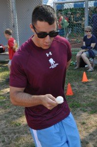 A team member from U.S. Marine Corps Forces Africa tries not to break his egg during the egg run at the AFRICOM Olympics Aug. 7. Held annually at Kelley Barracks, the AFRICOM Olympics offers a day of fun and camaraderie through sporting competitions, games and family entertainment.