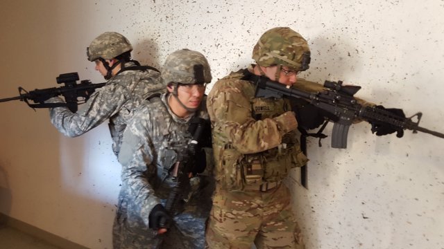 Three U.S. Soldiers assigned to 554th Military Police Company prepare to clear a room during a live fire event ring the annual 709th Military Police Battalion's D-Day Competition in the Boeblingen Local Training Area near Panzer Kaserne, Boeblingen, Germany Oct. 27, 2015.