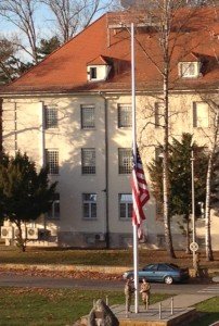 Service Members lower the flag on U.S. Army Garrison Stuttgart's Panzer Kaserne, Germany. U.S. flags fly at half-staff honoring victims of Paris terrorist attack Nov. 15-19, 2015.