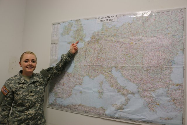 SPC Arica Wilson from the 587th Signal Company shares the new Travel Bucket List map as part of the Patch Barracks living quarters improvements. Photo by Stuttgart Family and MWR.