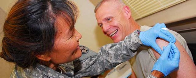 A medical provider administers the flu vaccination injection to a patient. U.S. Army Photo.