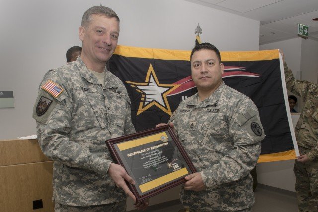 Col. Patrick Grady, U.S. Army Health Clinic Stuttgart commander, and Sgt. 1st Class Stephen Geiselhofer, the clinic’s noncommissioned officer in charge, show off the facility’s newest certification, the Voluntary Protection Program Army Safety Excellence Star following a ceremony Jan. 25. Achieving star status requires three stages of assessments focused on management leadership and employee involvement, worksite analysis, hazard prevention and control, and safety and health training. U.S. Army photo by Kevin Abel.