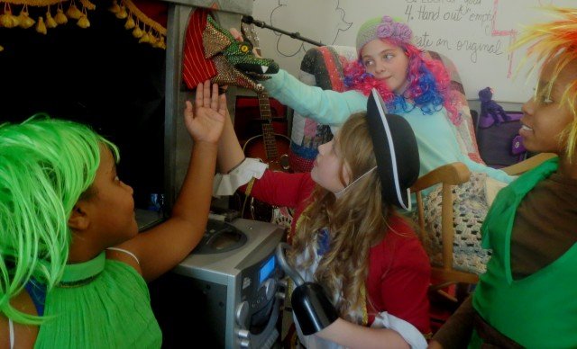 Stuttgart Elementary School students, Students, Sarah Husein, Sarah Webb (Tick Tock Dragon), Samantha Kitchin, Allyssa Shafer, and Alayla Simmons, create an original puppet and live performance for fellow fifth graders, Jan. 26.