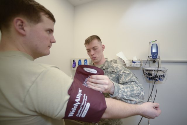 Spc. Elliott Hall, receives a blood pressure screening from Spc. Paul Mazako at the U.S. Army Health Clinic Stuttgart, Feb. 2. Keeping blood pressure in check can help reduce the risk of heart disease. Photo by Kevin S. Abel.