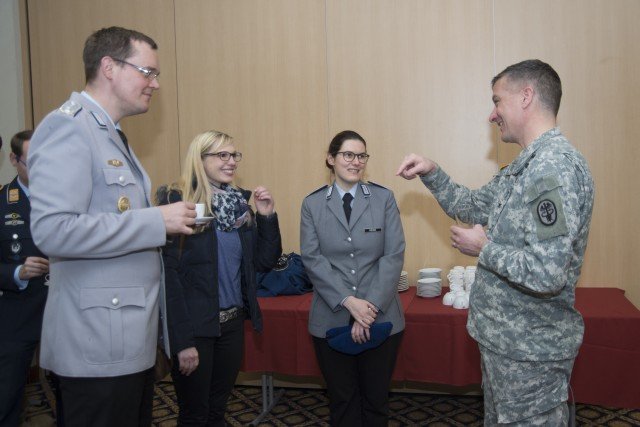 (Left to right) Col. Peter Schmidt, 1st Lt. Tina Höhne, and Carolin Greiner from Bundeswehrkrankenhaus Ulm speak with U.S. Army Col. Patrick Grady, Stuttgart Army Health Clinic commander, during a meeting March 2. The teams of health care professionals jointed to discuss effective management of refugees in an operational setting, as well as best practices during a public health emergency. Photo by Kevin S. Abel