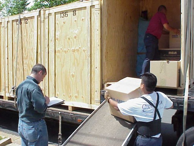 Workers load a truck.