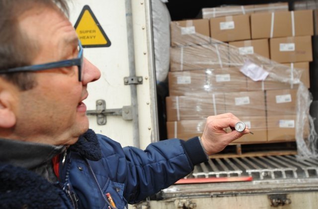 Photo Credit: Mr. Gino G Mattorano (Army Medicine) Gerald Fasching, a supervisory quality inspection specialist with Public Health Command Europe, checks the temperature of a shipping container arriving at Kaiserslautern Cold Storage Facility March 3. Food must be transported at specific temperatures to ensure it remains safe for consumption.