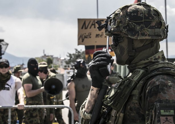 A German soldier calls in reinforcements as a group of angry protestors taunt the German Armed Forces during Operation Sharp Griffin held on Camp Prizren, Kosovo, May 7, 2016. Photo Credit: Staff Sgt. Thomas Duval.