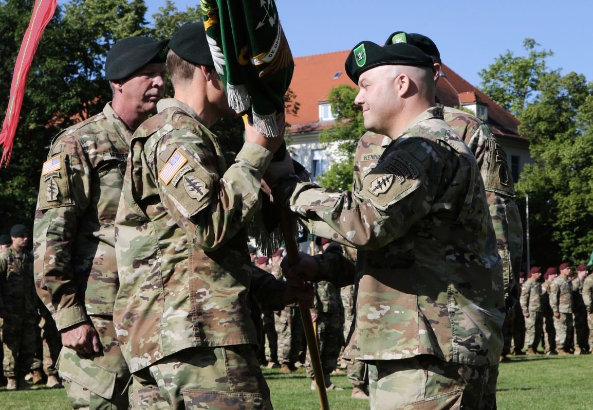 Incoming Commander, Lt. Col. Andrew R. Ries, 1st Battalion, 10th Special Forces Group (Airborne), receives the unit colors from Col. Isaac J. Peltier, commander 10th SFG(A) during the unit's change of command ceremony held on Panzer Kaserne, July 7, 2016. 1st Bn. 10th SFG(A) is one of two forward stationed battalions within Special Forces tracing its history to 10th SFG(A) establishment in Bad Tolz, Germany in 1953. 1st Bn. 10th SFG (A) moved Panzer Kaserne on Aug 1991 where it is still based today. U.S. Army photo by Staff Sgt. Larraine Whetstone