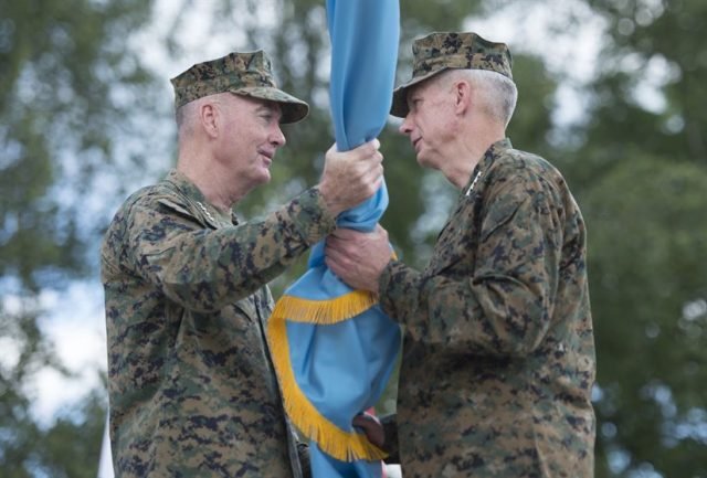 Marine Corps Gen. Joe Dunford, chairman of the Joint Chiefs of Staff, left, passes the U.S. Africa Command flag to Marine Corps Gen. Thomas D. Waldhauser, incoming commander of Africom, during the Africom change of command ceremony at U.S. Army Garrison Stuttgart, Germany, July 18, 2016. Waldhauser assumed command from Army Gen. David M. Rodriguez, who will retire after 40 years of military service. DoD photo by Navy Petty Officer 2nd Class Dominique A. Pineiro
