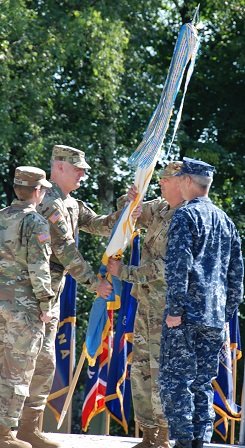 Col. Andrew S. McClelland receives the colors from the Defense Information Systems Agency- Europe Director, Lt. Gen. Alan R. Lynn, during a change of command ceremony on Patch Barracks, July 8, 2016. McClelland assumes command from Col. Jacqueline D. Brown. Photo by Master Sgt. Anthony O'Brien, DISA-Europe 