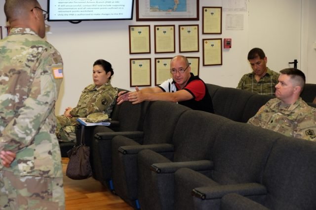 Master Sgt. Kevin Watts, noncommissioned officer in charge, Retirement Services Office, 99th Regional Support Command, left, briefs Lt. Col. Jason Welch, 7th Mission Support Command, center, during the 7th MSC hosted bi-annual 99th Regional Support Command Retirement Services Office preretirement brief, Aug. 20, 2016. Photo By Sgt. 1st Class Matthew Chlosta.