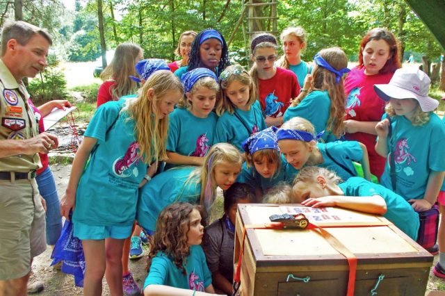 Girl Scouts of Stuttgart surround a beekeeper’s box to learn about bees and the harvesting of honey during the Magical Adventures in Scouting day camp held, Aug. 8-12, 2016 in Böblingen, Germany. Photo Credit: Marlieke Eaton