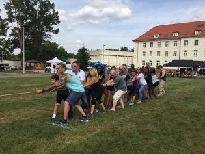 Family and Morale, Welfare and Recreation staff compete in a friendly game of tug-o-war during the garrison's Organization Day, Sept. 2, 2016 on Panzer Kaserne. 