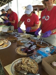 Volunteers from the Red Cross hep serve dessert entries from garrison employees at the U.S. Army Garrison Stuttgart's Organization Day, Sept. 2, 2016 on Panzer Kaserne. Photo by Holly DeCarlo-White 