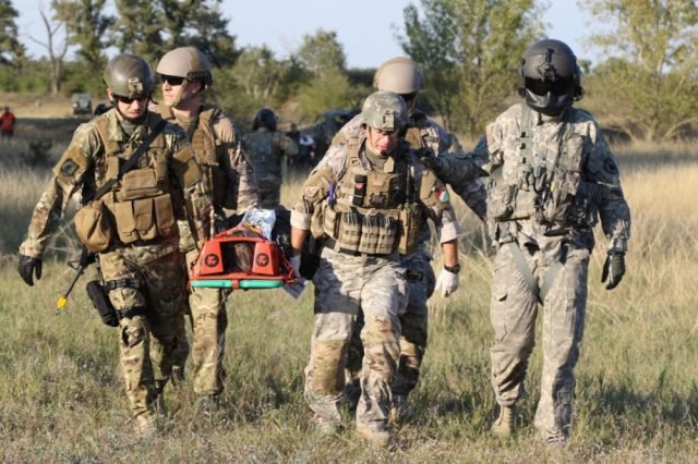 Hungarian Special Operations service members conduct nine-line casualty evacuation training with the Army National Guard helicopter taskforce September 23. Photo by Staff Sgt. Larraine Whetstone/24th Press Camp HQ